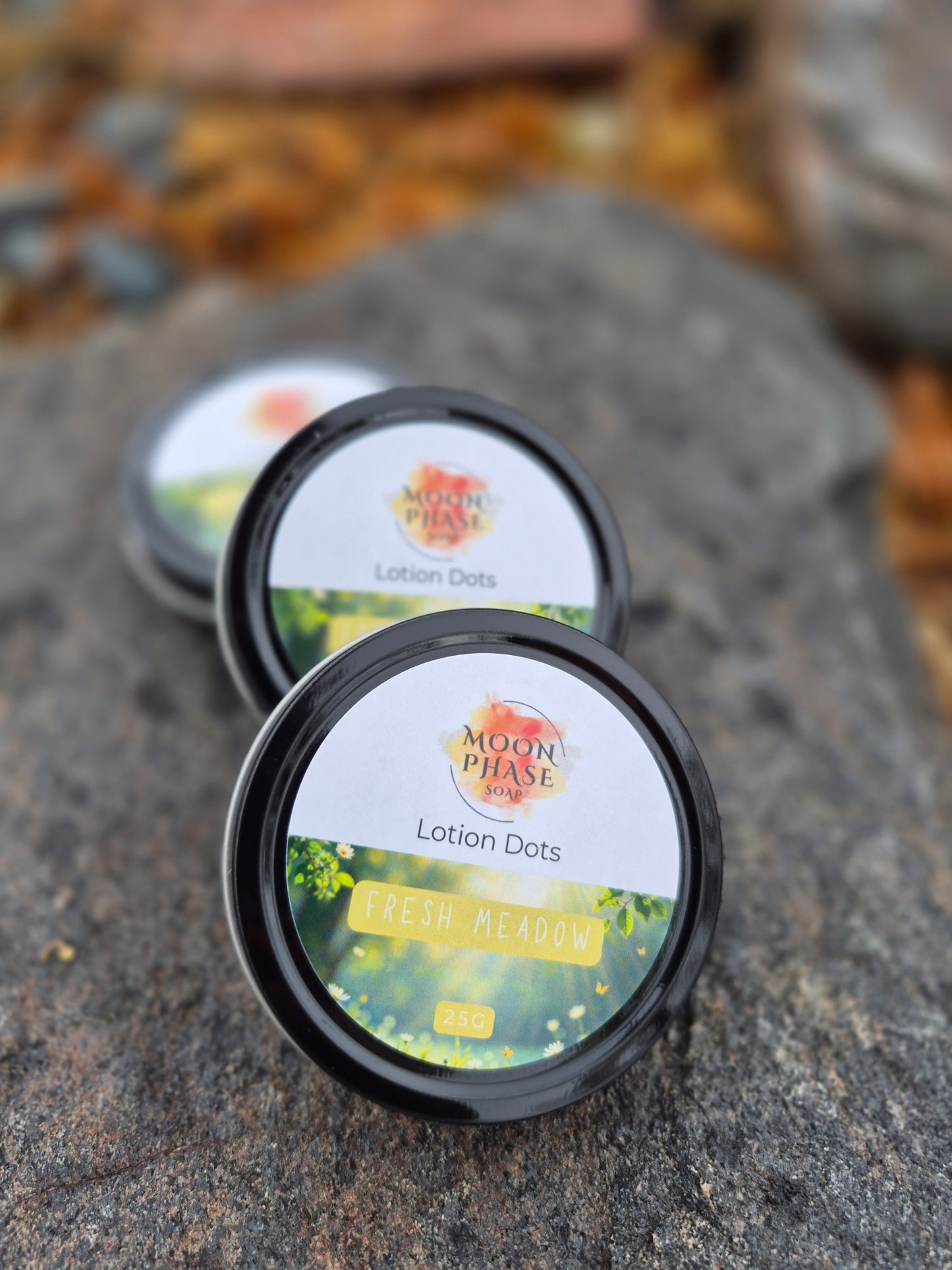 Open tin of Moon Phase Soap Fresh Meadow Lotion Dots